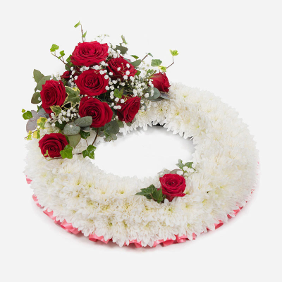 Wreath SYM-314 - White Massed Wreath with Red Rose Spray. A classic arrangement to send for a funeral. 
